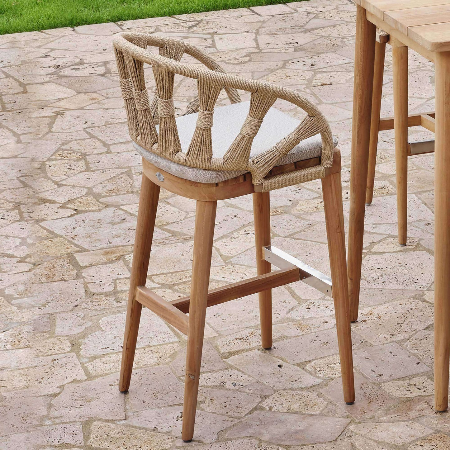 Krabi Hanging Dining Armchair features an elegant rope-wrapped frame, sculpted curves, and a warm teak base.