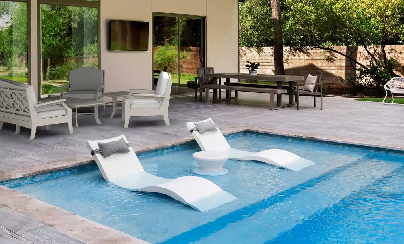 Designed for tanning ledges, baja shelves, or sun shelves with water depths up to 9 inches, this set includes two Signature In-Pool Chaise Loungers, two plush Headrest Pillows, and a versatile Side Table.