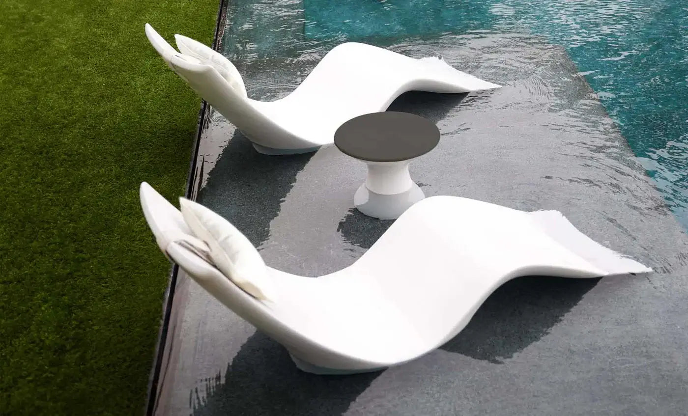This premium set includes two Autograph In-Pool Chaise Loungers, two plush Headrest Pillows, and a sleek Autograph Standard Side Table, offering everything you need to create a sophisticated outdoor oasis.
