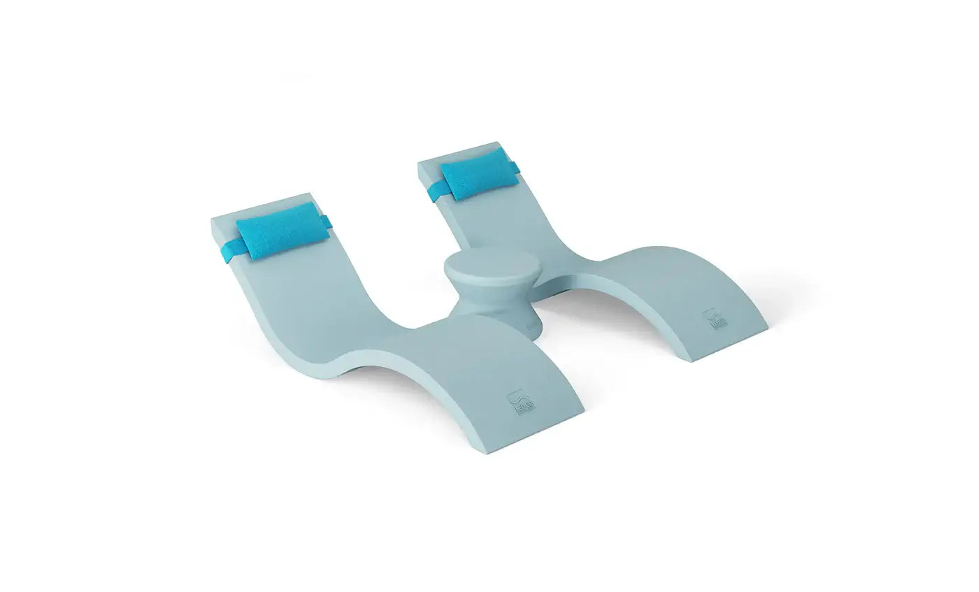 Designed for tanning ledges, baja shelves, or sun shelves with water depths up to 9 inches, this set includes two Signature In-Pool Chaise Loungers, two plush Headrest Pillows, and a versatile Side Table.