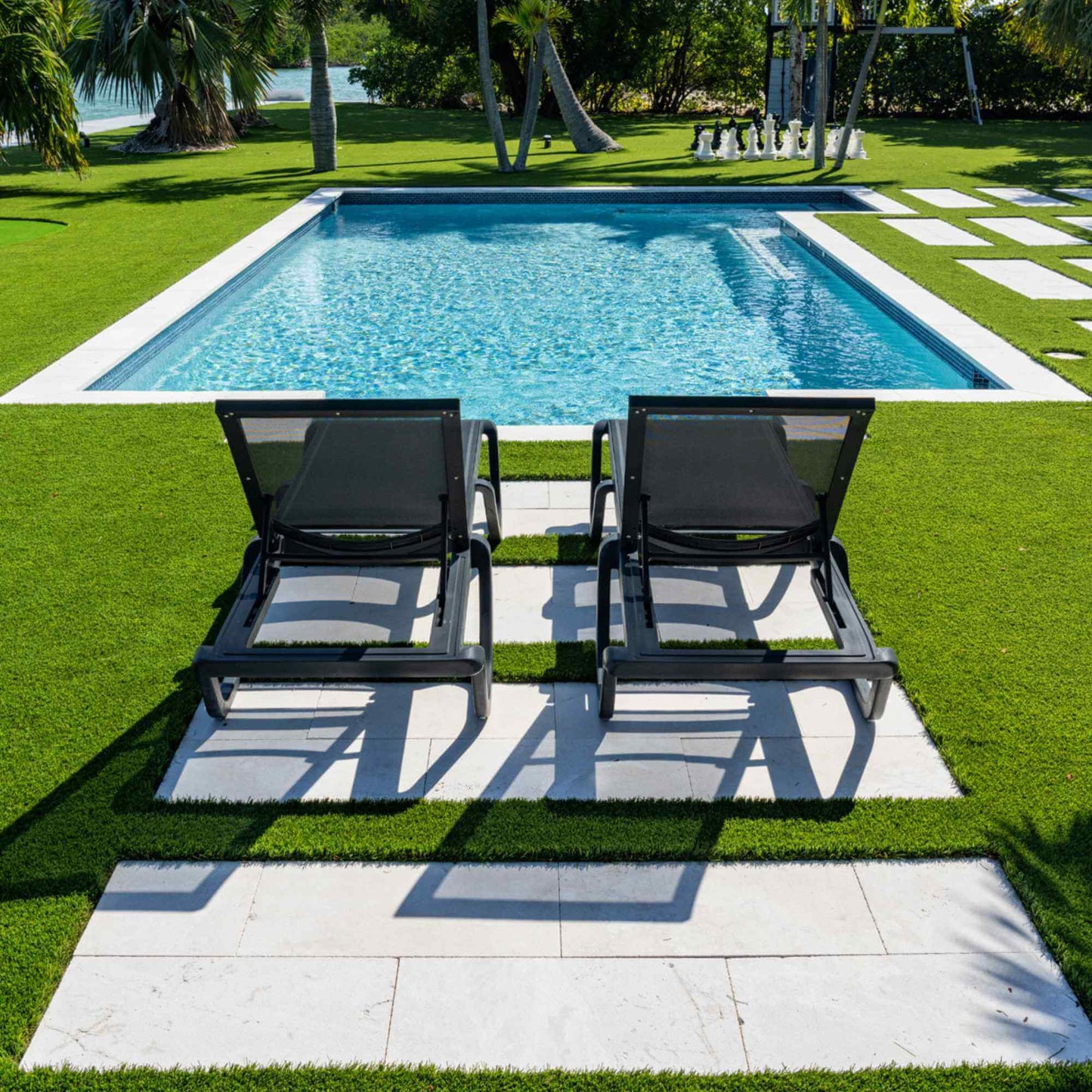 Black set of 2 outdoor sling chaise loungers that are commercial-grade quality for durability and heavy use