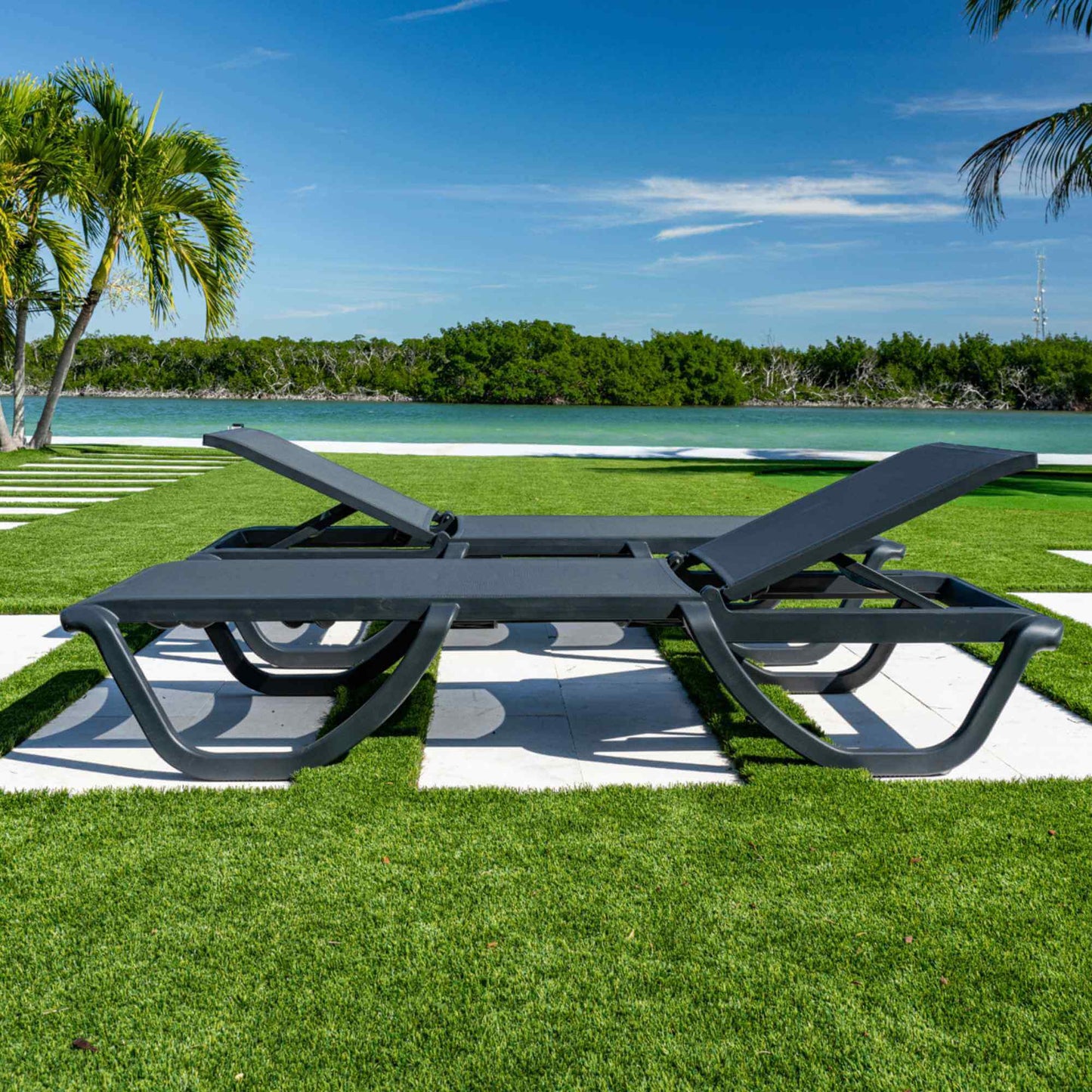 Black set of 2 outdoor sling chaise loungers that are commercial-grade quality for durability and heavy use