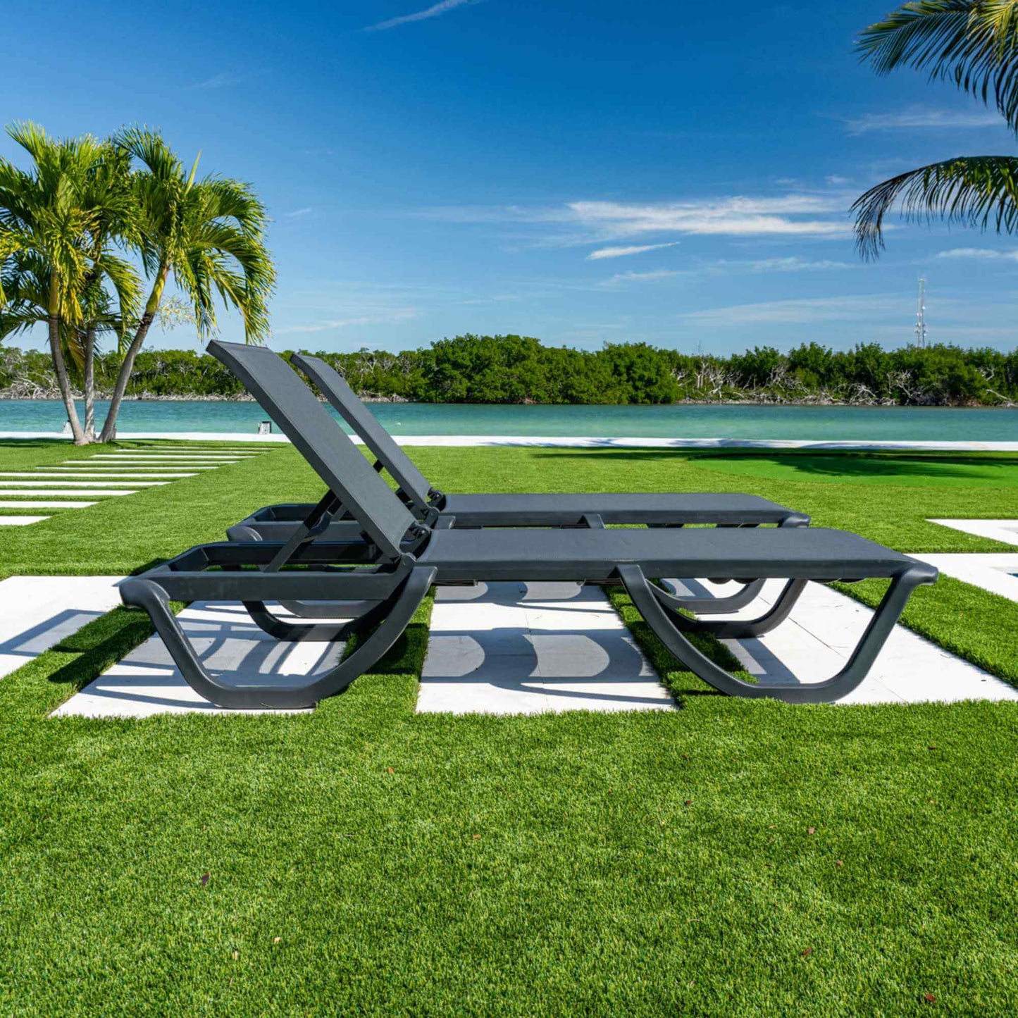 Black set of 2 outdoor sling chaise loungers that are commercial-grade quality for durability and heavy use