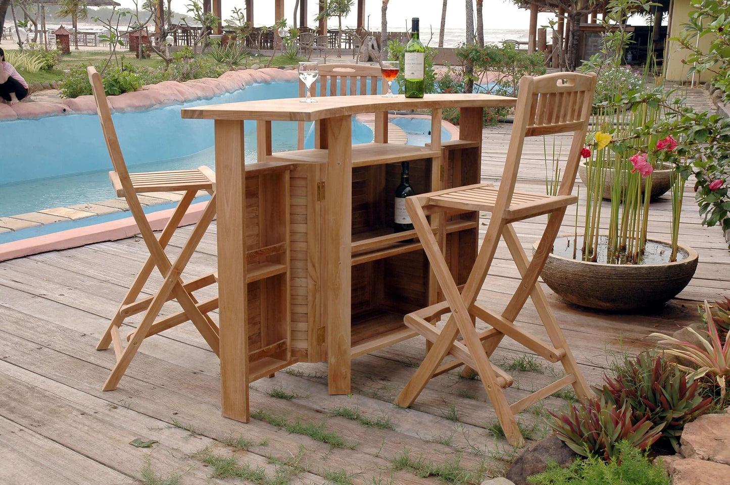 Anderson Teak 5-piece outdoor folding bar table set that has an expandable folding table top for ample storage space and folding bar stools