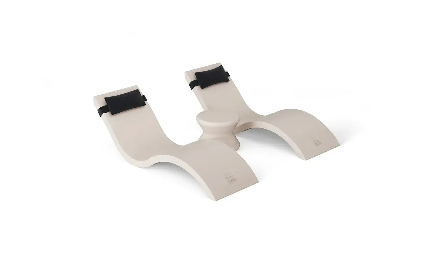 Designed for tanning ledges, baja shelves, or sun shelves with water depths up to 9 inches, this set includes two Signature In-Pool Chaise Loungers, two plush Headrest Pillows, and a versatile Side Table.