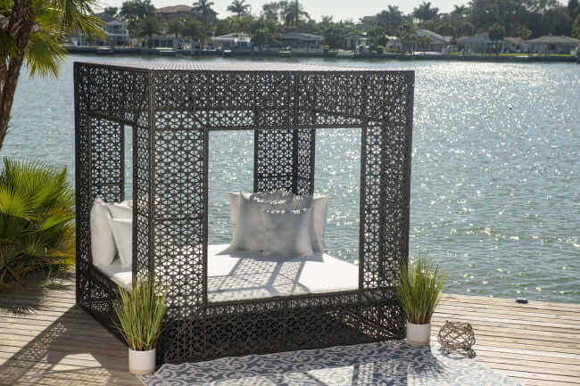 Panama Jack cube-shaped outdoor daybed built with weather-resistant materials to accommodate up to four people