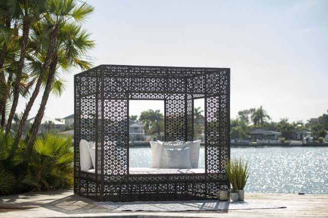 Panama Jack cube-shaped outdoor daybed built with weather-resistant materials to accommodate up to four people