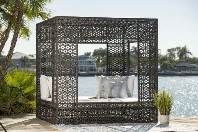 Panama Jack cube-shaped outdoor daybed built with weather-resistant materials to accommodate up to four people