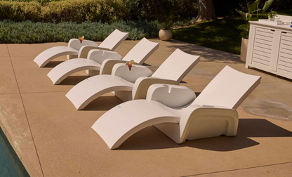 Four Signature Chaise Armrest Consoles arranged poolside on a tanning ledge