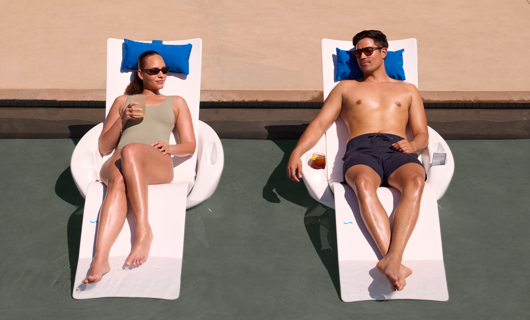 Couple relaxing on Autograph Chaises with Armrest Consoles on a tanning ledge