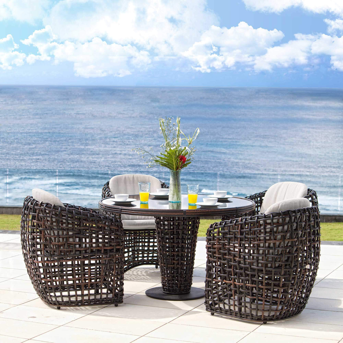 Outdoor patio set with round table and chairs by the ocean