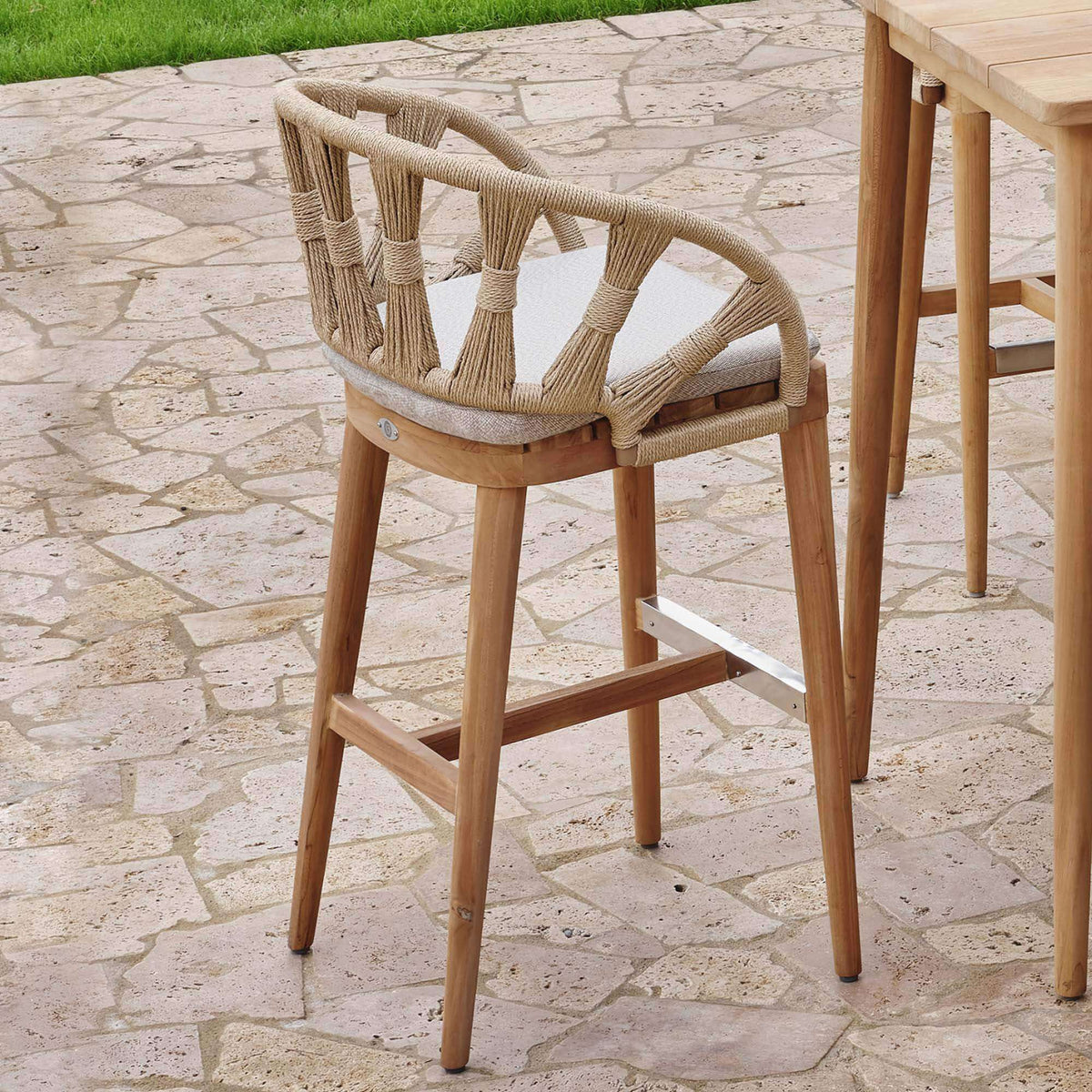 Krabi Hanging Dining Armchair features an elegant rope-wrapped frame, sculpted curves, and a warm teak base.