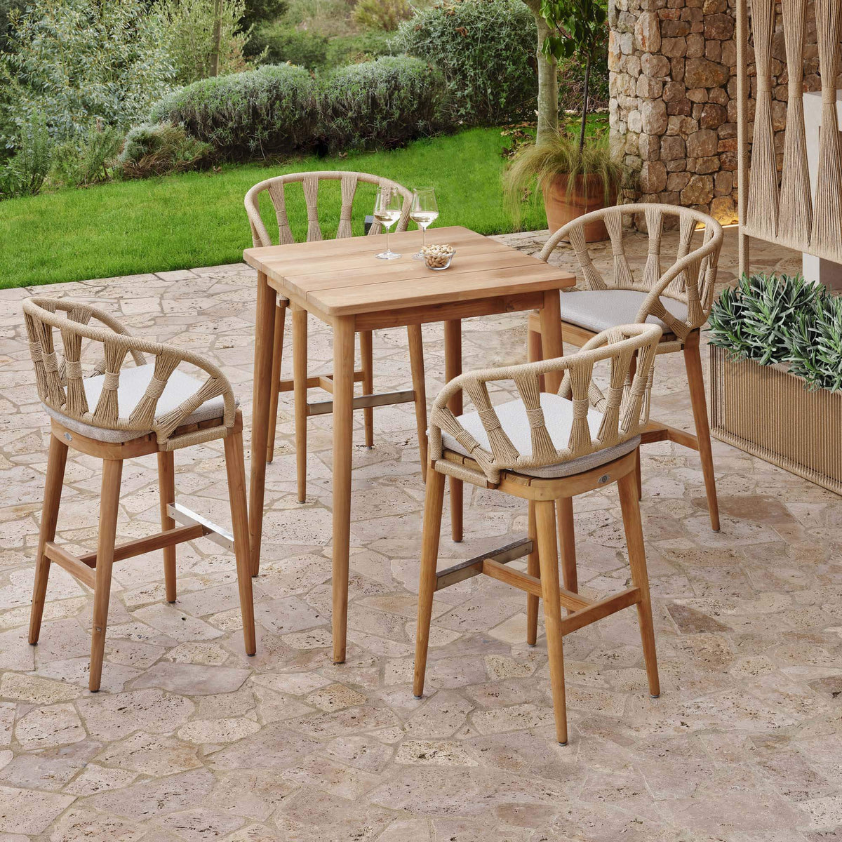 Krabi Hanging Dining Armchair features an elegant rope-wrapped frame, sculpted curves, and a warm teak base.