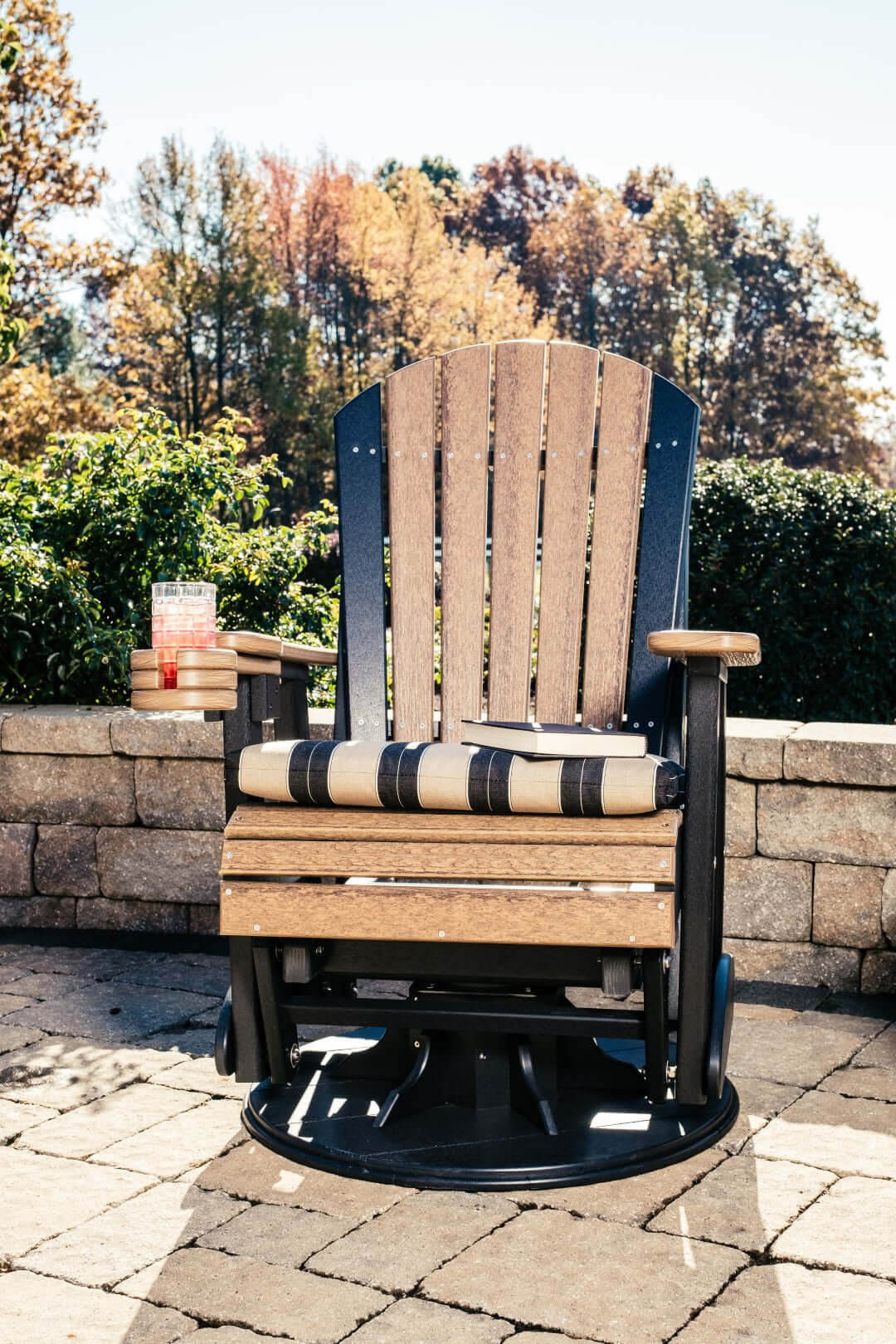 LuxCraft 2' Adirondack Swivel Glider in Antique Mahogany and Black paired for patio rotation seating — weather-resistant design
