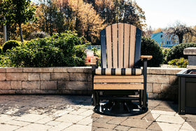 LuxCraft 2' Adirondack Swivel Glider in Antique Mahogany and Black arranged for pool deck conversation — durable poly construction