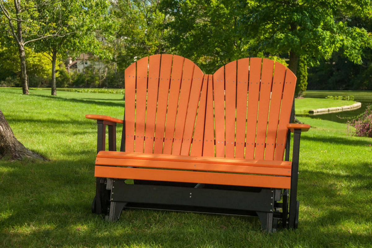 LuxCraft 4' Adirondack Glider in Tangerine and Black positioned for outdoor use — all-weather outdoor build