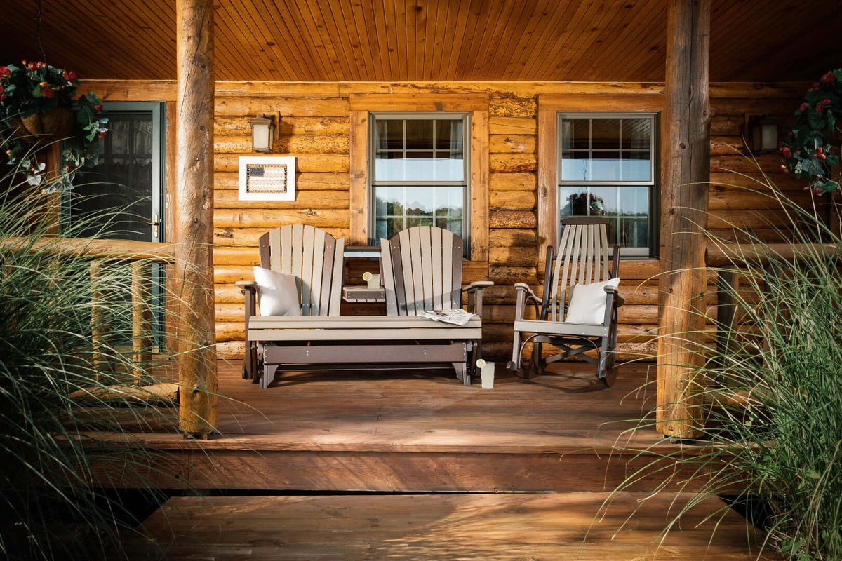 LuxCraft 5' Adirondack Glider in Weatherwood and Chestnut Brown positioned for outdoor use — all-weather outdoor build