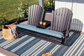 LuxCraft 5' Adirondack Swing in Black arranged for front-porch use — durable poly construction