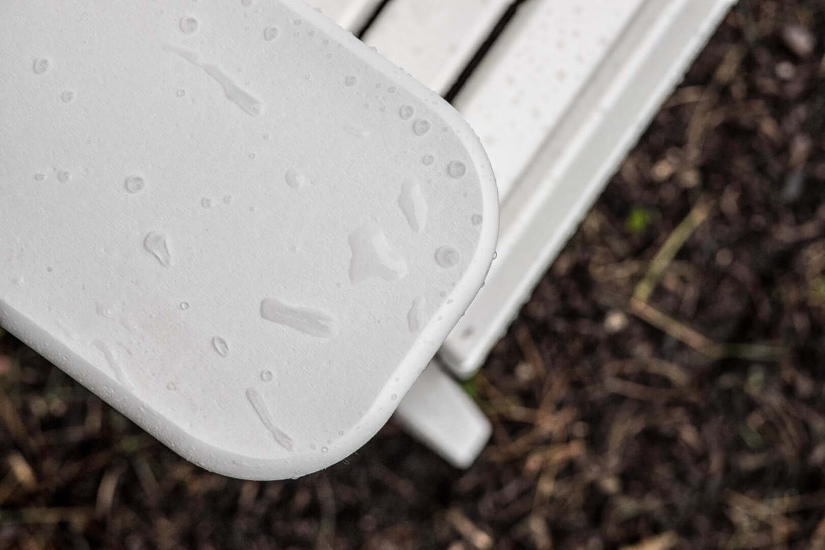 LuxCraft 4' Plain Outdoor Bench armrest detail — recycled poly slat-top bench with stainless hardware