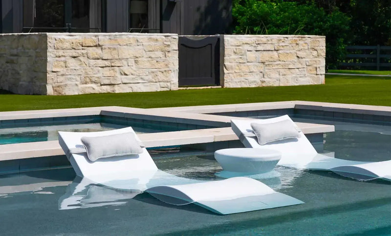 Designed for tanning ledges, baja shelves, or sun shelves with water depths up to 9 inches, this set includes two Signature In-Pool Chaise Loungers, two plush Headrest Pillows, and a versatile Side Table.