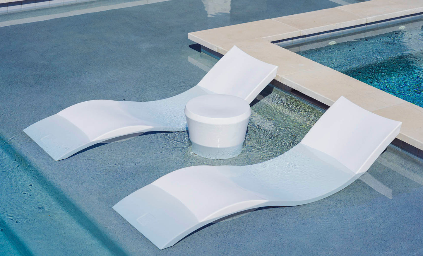 Affinity Side Table and lounge chairs partially submerged on a shallow tanning ledge