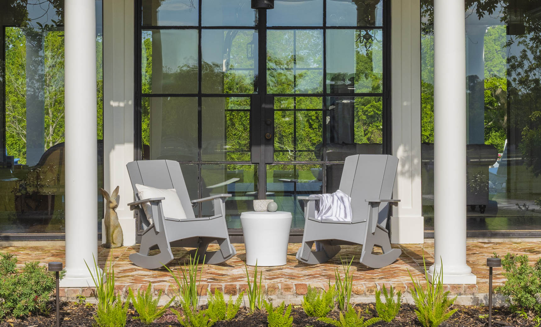 Affinity Side Table used on a porch between two rocking chairs