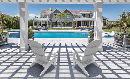 White Legacy Adirondack chairs under a pergola beside a pool