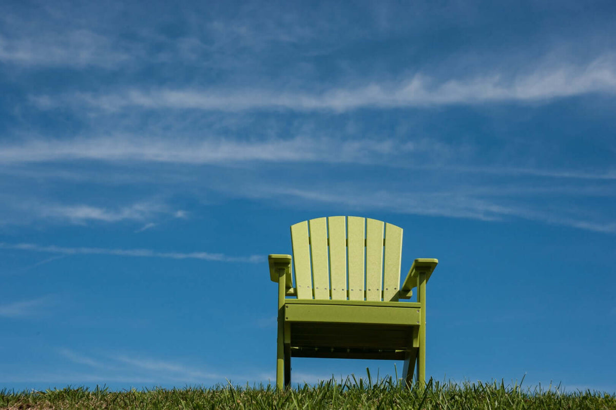 LuxCraft Lakeside Adirondack Chair in Lime Green positioned for backyard relaxation — all-weather outdoor build