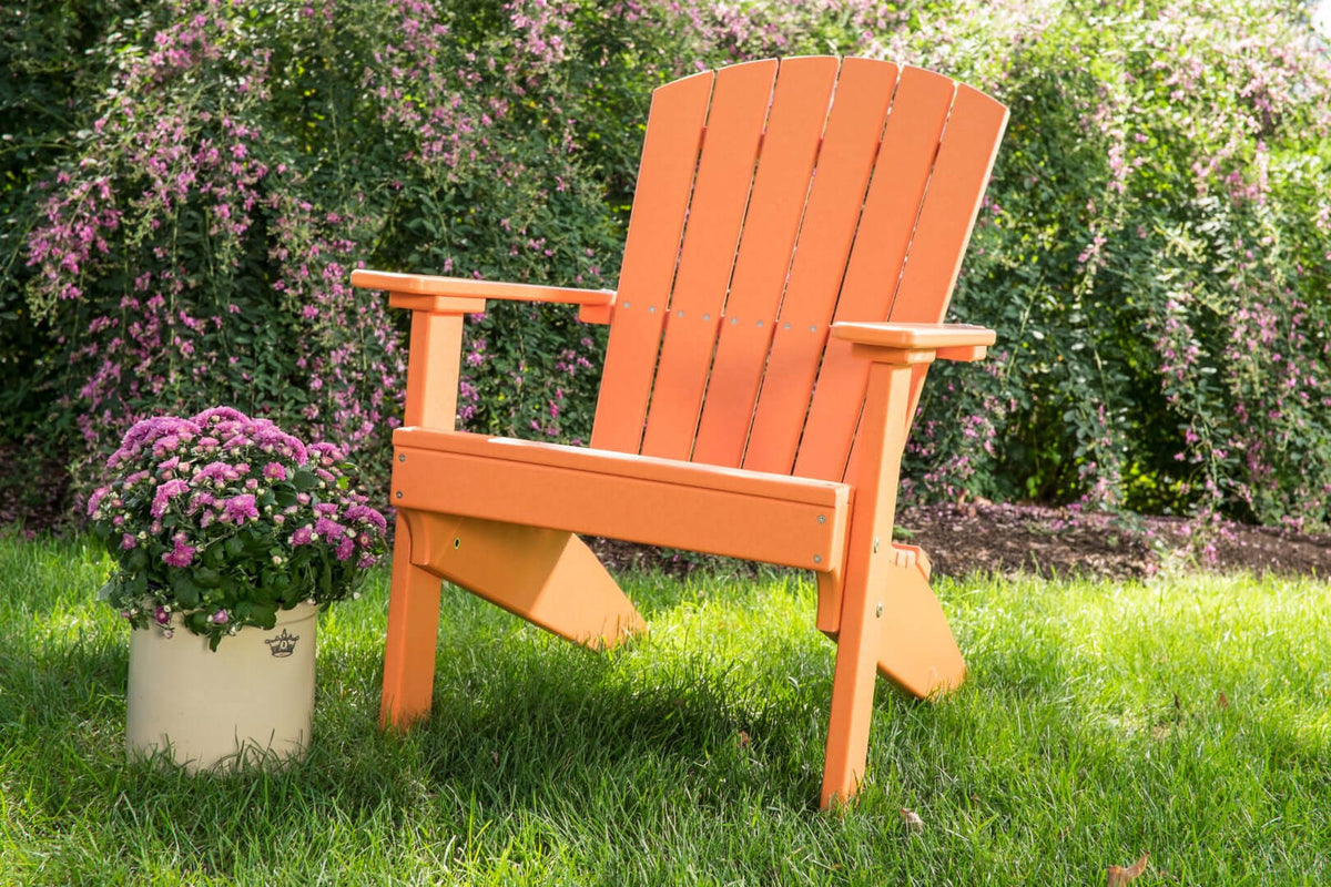 LuxCraft Lakeside Adirondack Chair in Tangerine styled for patio lounging — 20-year poly durability