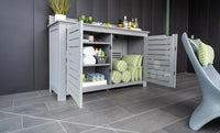 Outdoor storage cabinet with open doors displaying towels and items on a tiled patio.