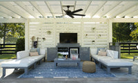 Outdoor patio with gray furniture, TV, and decorative items under a white pergola.