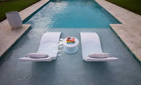Designed for tanning ledges, baja shelves, or sun shelves with water depths up to 9 inches, this set includes two Signature In-Pool Chaise Loungers, two plush Headrest Pillows, and a versatile Side Table.