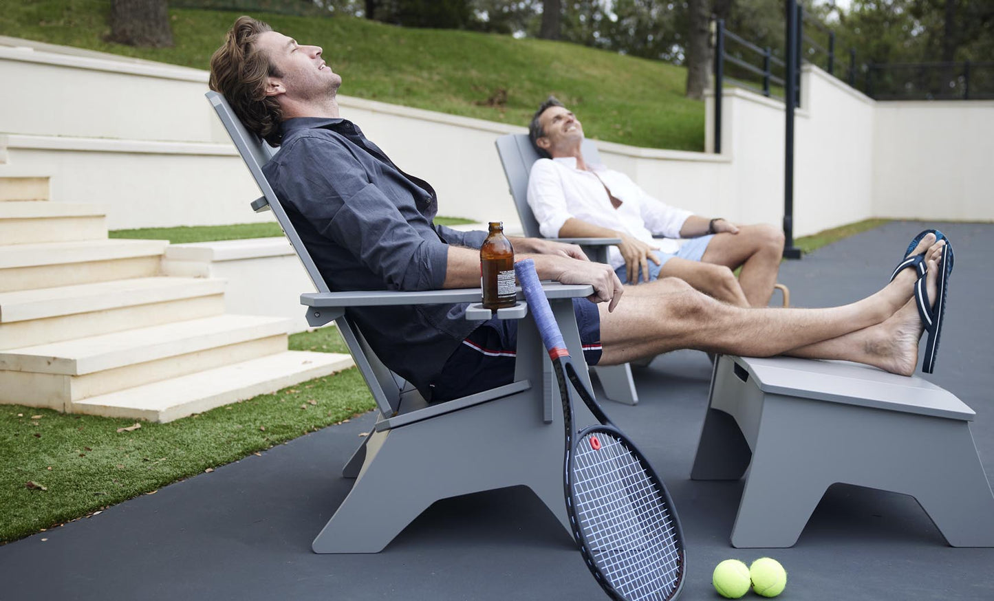 Mainstay Adirondack chair and matching ottoman in gray on a patio