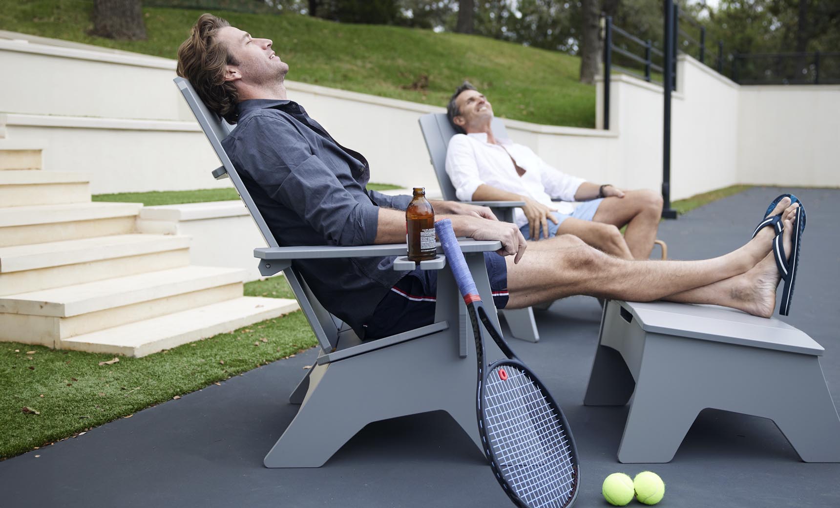Mainstay Adirondack chair and matching ottoman in gray on a patio