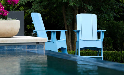 Sky Blue Mainstay Adirondack Tall chairs poolside among greenery