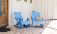 Two blue rocking chairs with a striped pillow on a wooden floor.