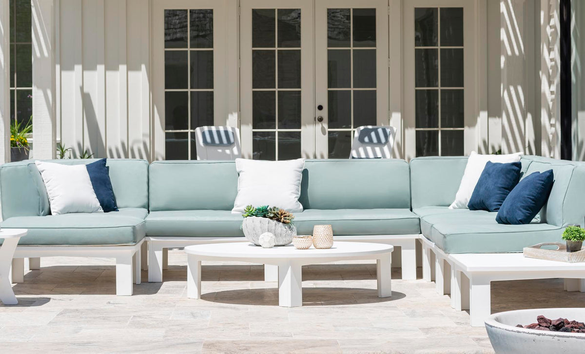 Mainstay Round Coffee Table on a modern patio with a light blue sectional