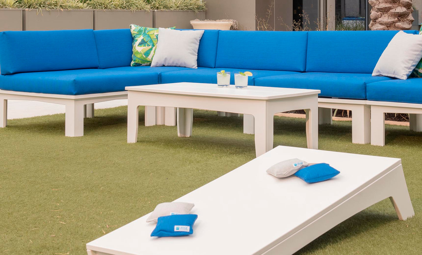 Mainstay Rectangular Coffee Table with blue cushioned seating in an outdoor space