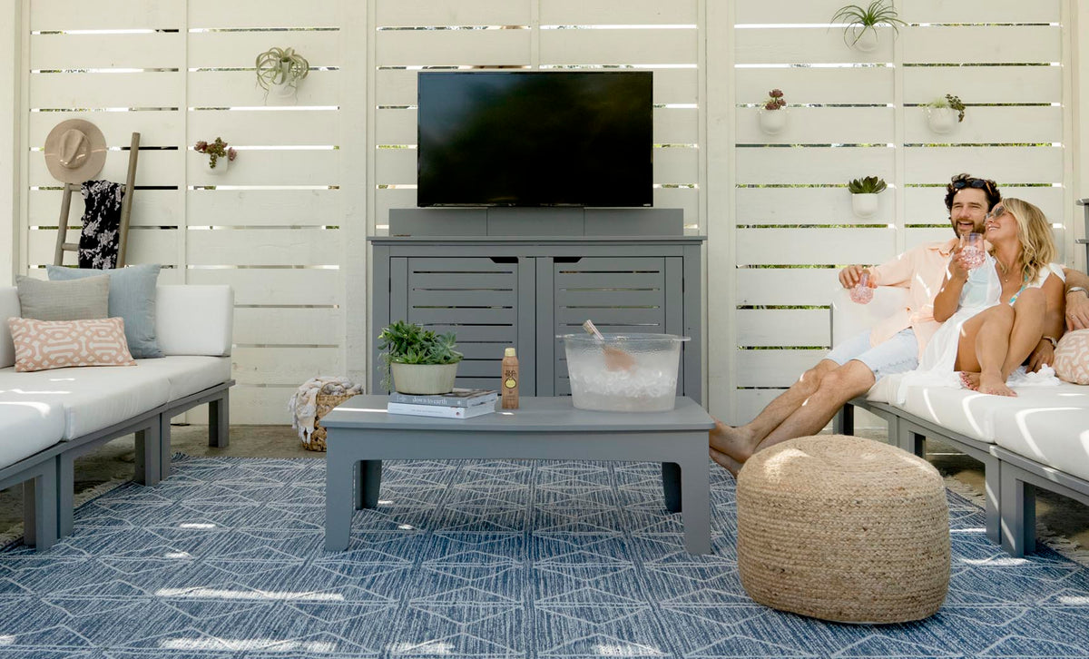 Gray Mainstay Rectangular Coffee Table in a covered patio lounge setting