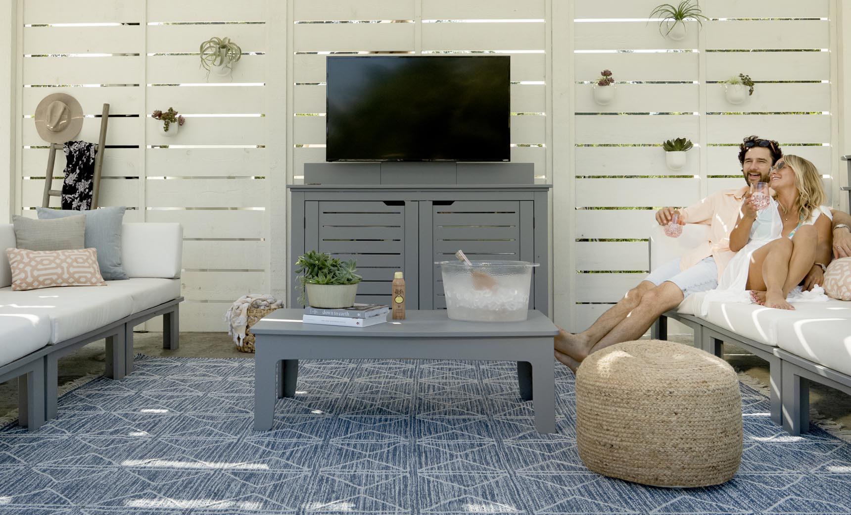 Gray Mainstay Rectangular Coffee Table in a covered patio lounge setting