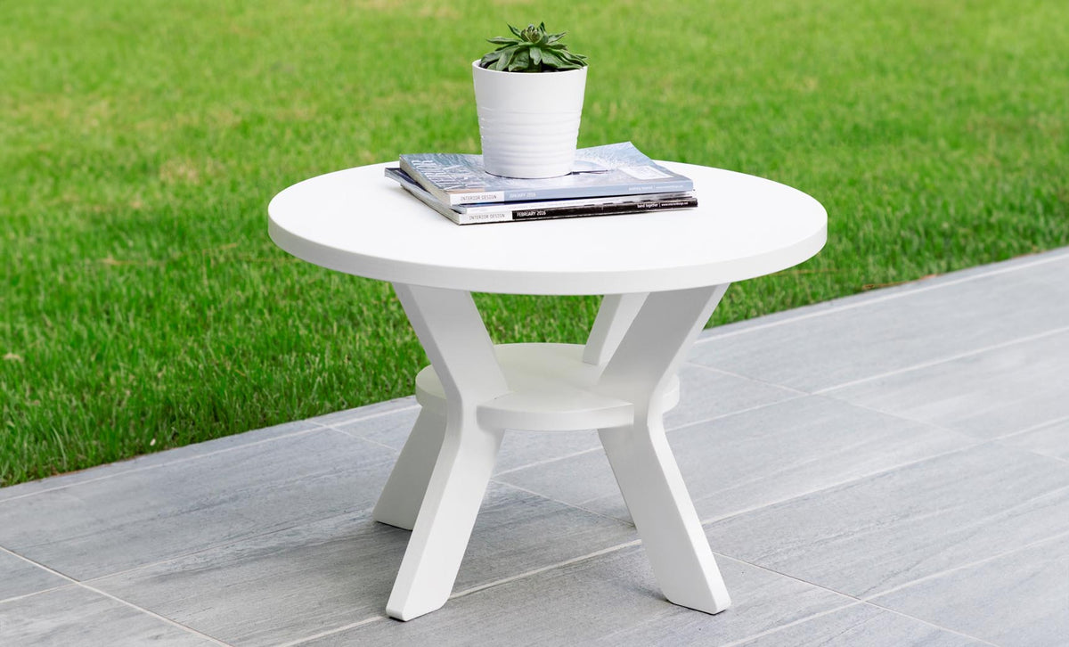Mainstay Round Side Table on a tiled patio holding a small planter and magazines