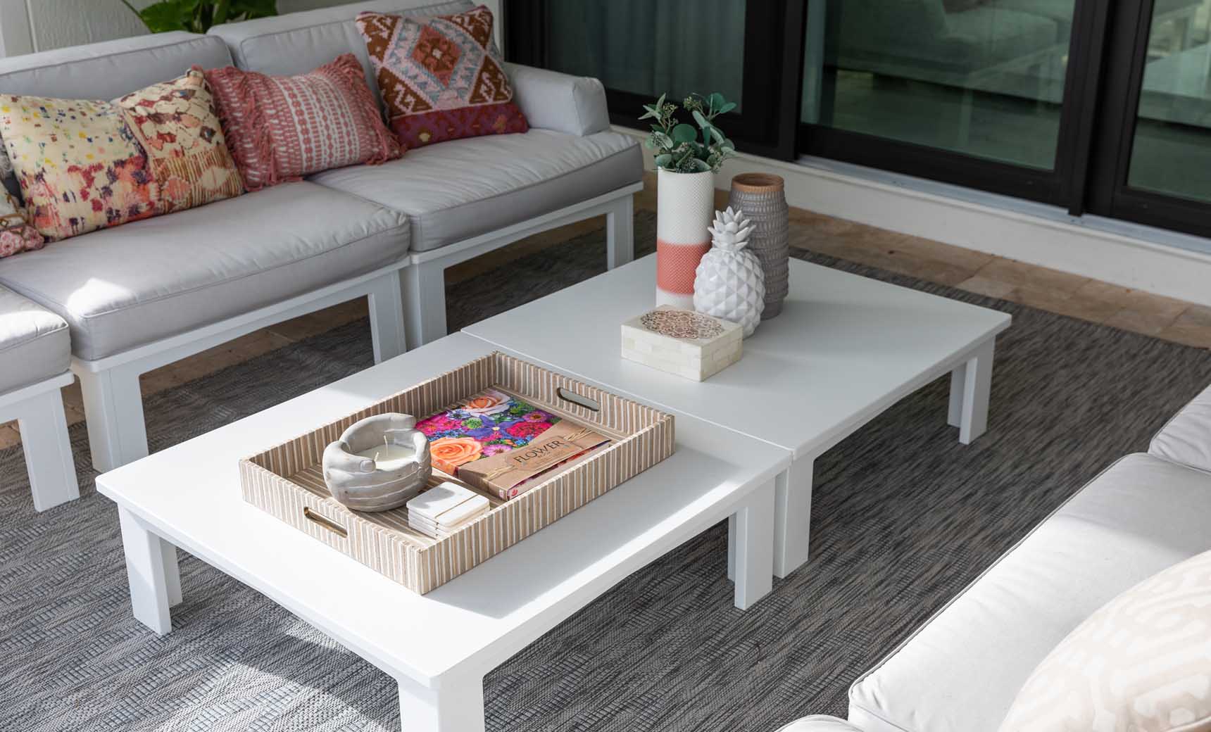 Mainstay Square Coffee Table with a tray and plant in a bright outdoor lounge