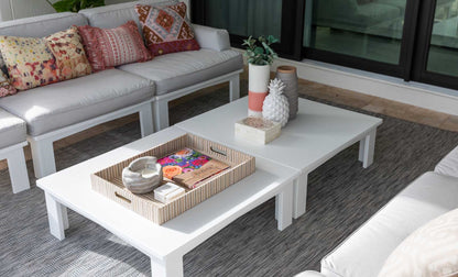 Mainstay Square Coffee Table with a tray and plant in a bright outdoor lounge