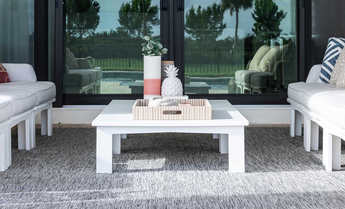Mainstay Square Coffee Table styled at the center of a white patio sectional
