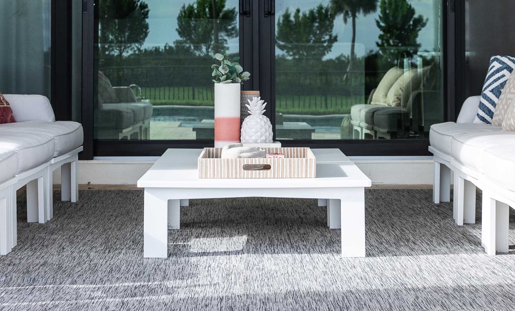 Mainstay Square Coffee Table styled at the center of a white patio sectional