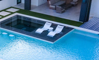 Designed for tanning ledges, baja shelves, or sun shelves with water depths up to 9 inches, this set includes two Signature In-Pool Chaise Loungers, two plush Headrest Pillows, and a versatile Side Table.