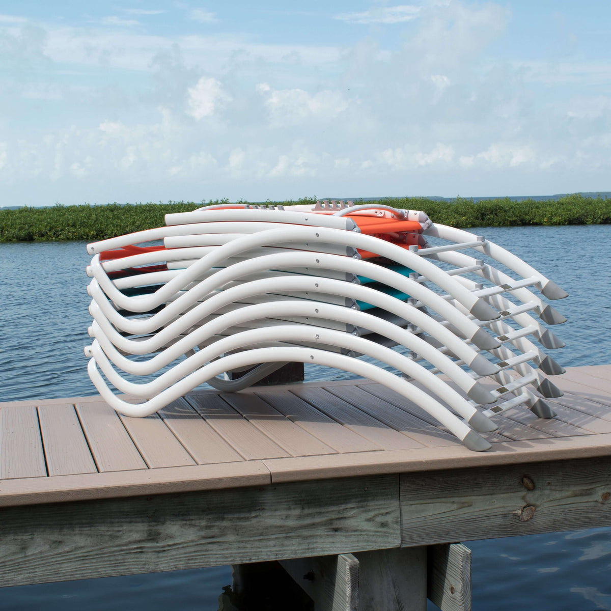 Grey durable sling material stackable outdoor chaise lounge chair featuring a white extruded aluminum frame