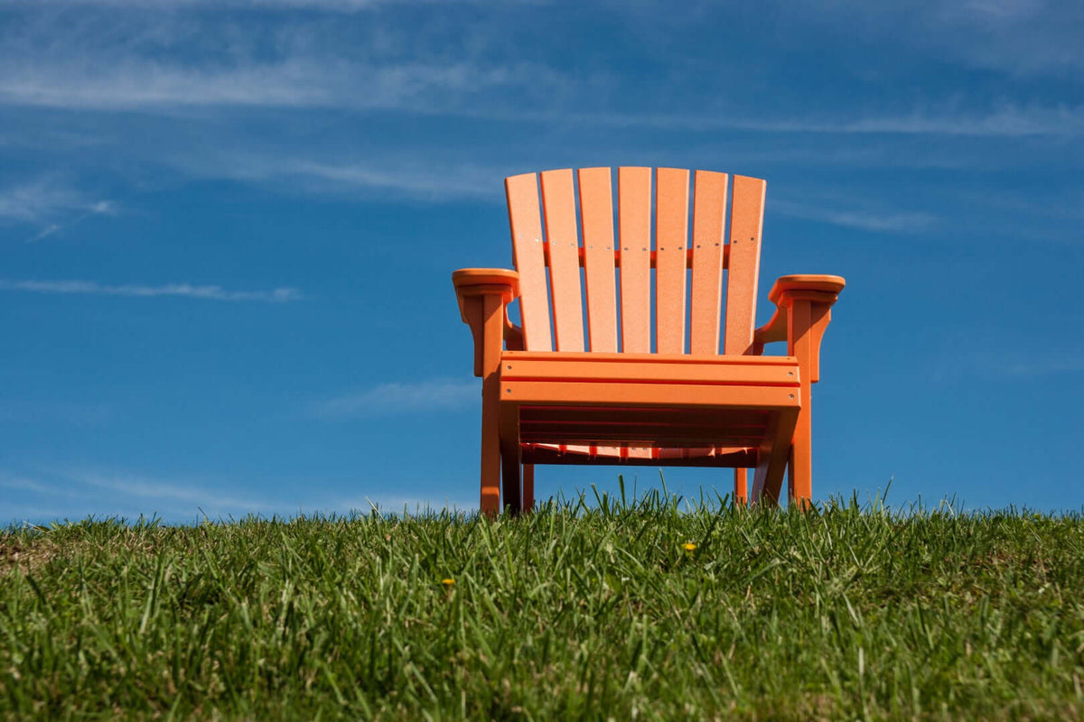 LuxCraft Deluxe Adirondack Chair in Tangerine — angled-back lounge design, fade-resistant poly