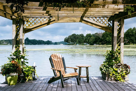 LuxCraft Folding Adirondack Chair in Cedar and Black arranged for backyard relaxation — durable poly construction