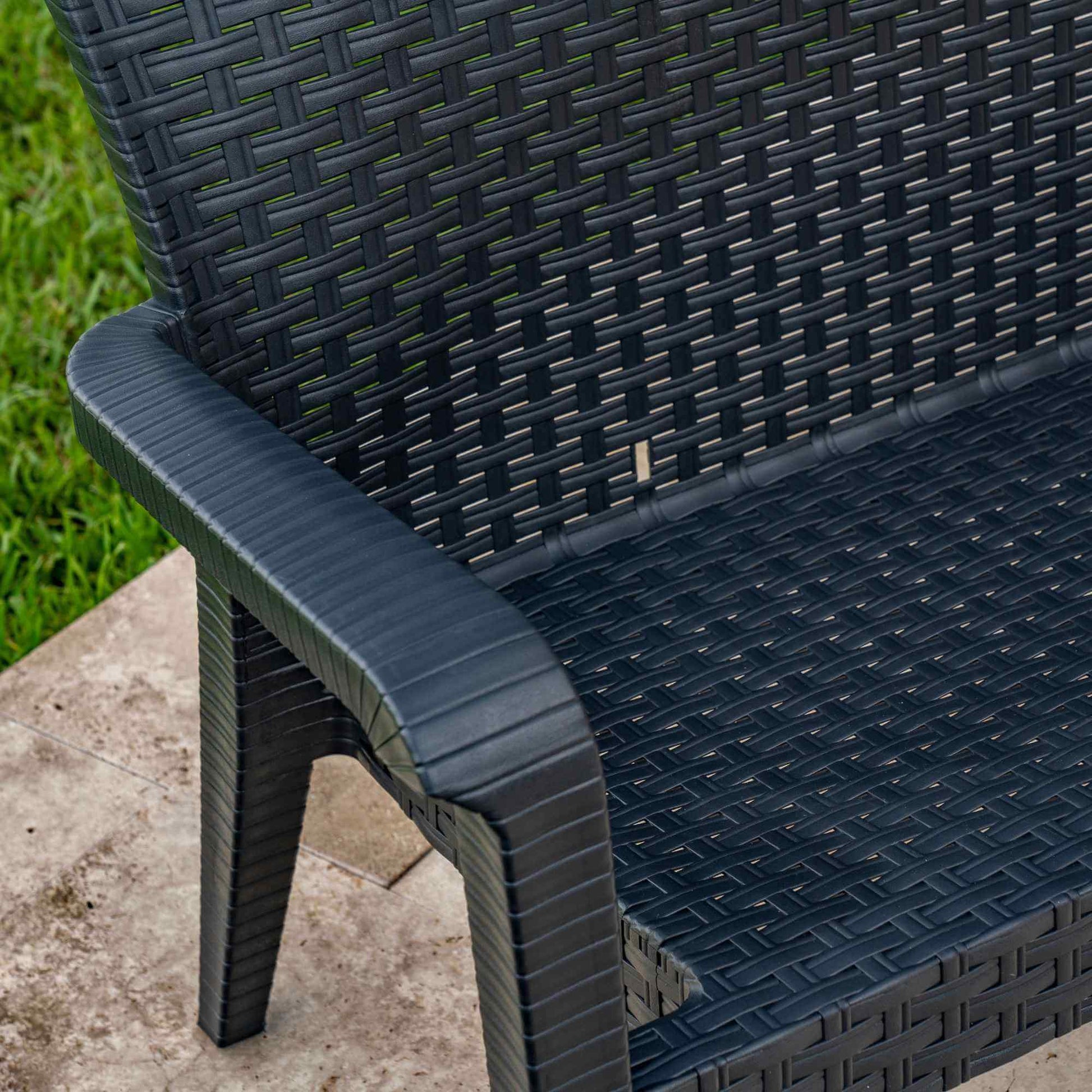 Black outdoor stackable armchairs made of UV protected plastic piping